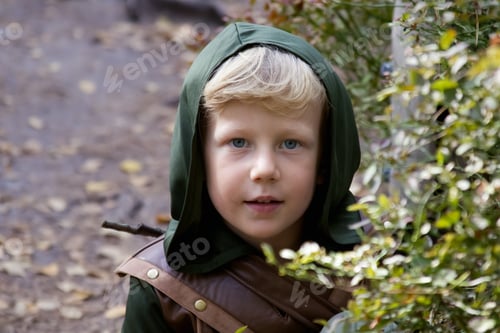 Preview: Close up portrait of a boy in a medieval costume against a forest background