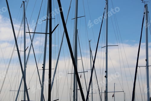 Preview: Closeup view of various masts of sailing ships on a sunny summer day