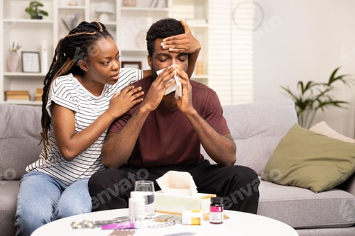 Preview: Caring Partner Comforting Sick Man at Home