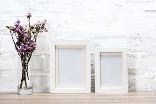 Preview: close up view of empty photo frames and flowers in vase
