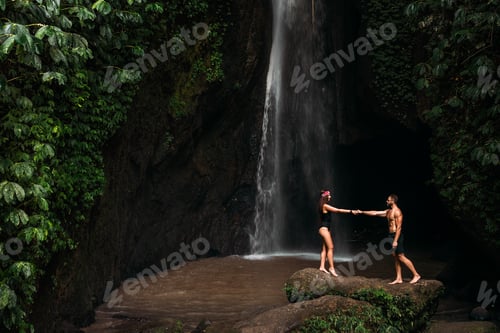 Preview: A couple in love on a waterfall. Honeymoon trip. Happy couple on the island of Bali