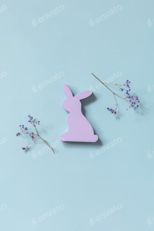 Preview: Happy Easter concept with purple rabbit, gypsophila flowers on a blue background.