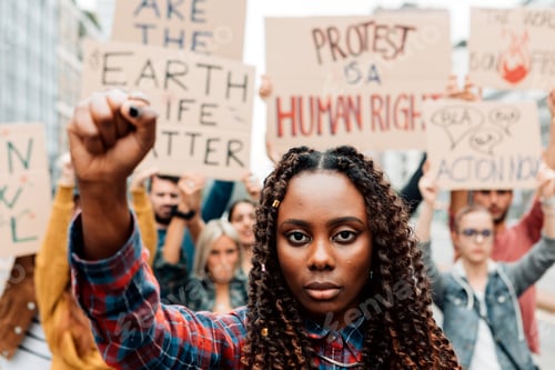 Preview: portrait of an african american woman with clenched fist in a global climate strike