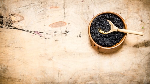 Preview: Black caviar in a bowl with a wooden spoon.