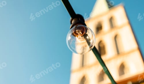 Preview: Light bulb on blue sky background.