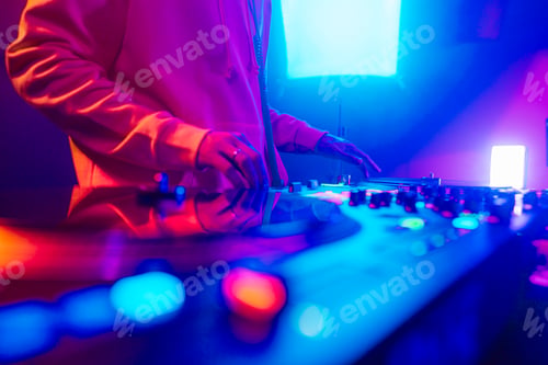 Preview: Hands of a DJ creating and regulating music on dj console mixer at club concert