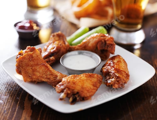 Preview: bbq buffalo chicken wings with celery and ranch on plate