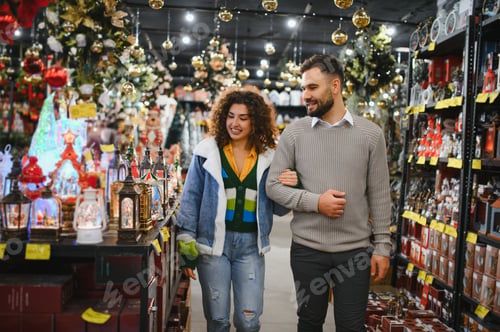 Preview: Couple shopping for christmas holiday decorations in store