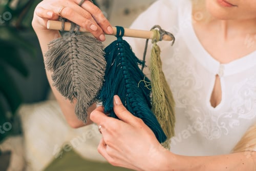 Preview: Woman weaving macrame in a home workshop.Handmade concept.