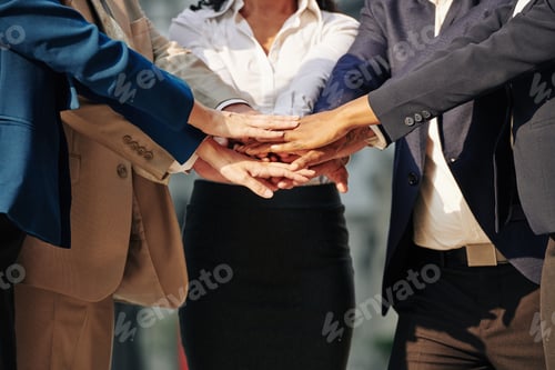 Preview: Business team stacking hands