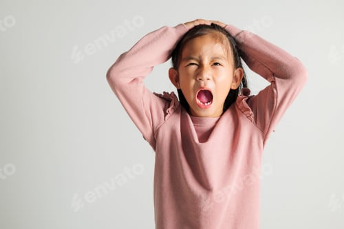 Preview: Asian portrait young kid girl standing angry and mad raising fist frustrated and furious while