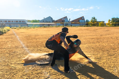 Preview: Baseball player sliding into base during game