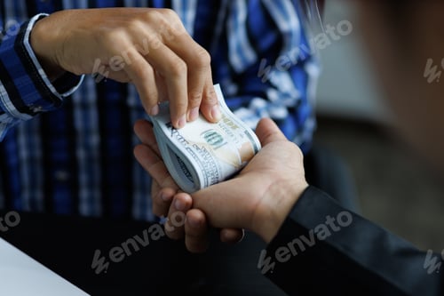 Preview: Man giving cash banknotes to businessman. The concept of cheating and bribery of officials.