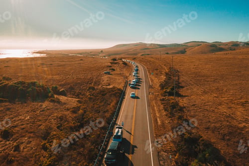 Preview: Aerial shot of a road traffic in beautiful nature under a blue clear sky