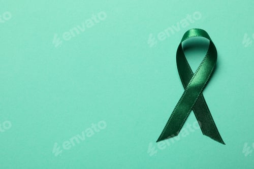 Preview: Green awareness ribbon on green background, top view