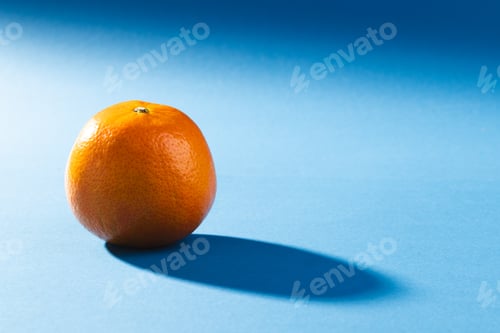 Preview: Close up of orange and copy space on blue background