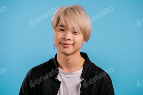 Preview: Portrait of stylish korean man looking to camera. Asian guy with dyed blonde hairstyle in studio