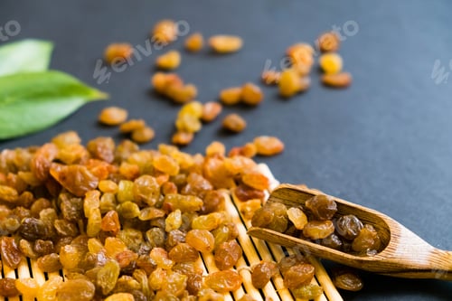 Preview: Raisins on a wooden spoon. Natural light.