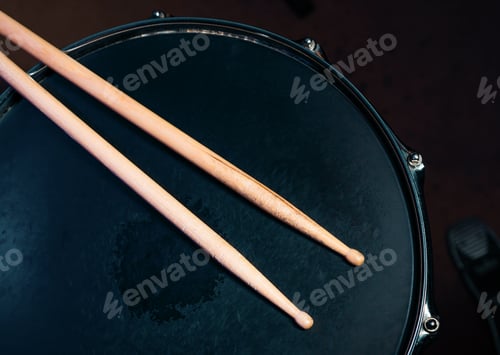 Preview: Drumsticks on a black snare background. Beautiful drumsticks. Music, concert concept.