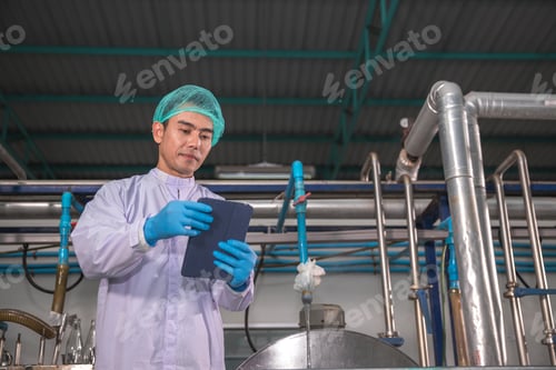 Preview: Worker Checking quality or checking stock of glass bottle in beverage factory.