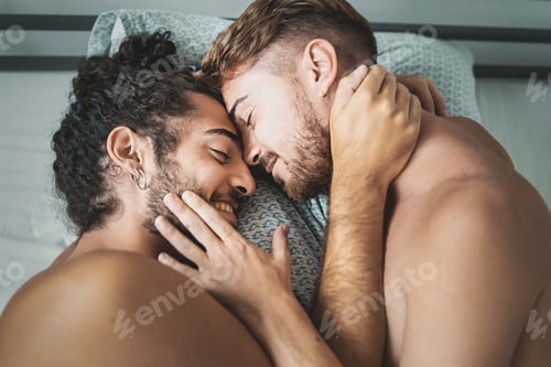 Preview: Homosexual male couple caressing shirtless in the bed - LGBT Gay lifestyle concept