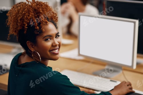 Preview: High angle portrait of a young female university student studying in the library