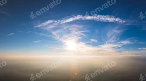 Preview: Bright colorful sunset sky with setting sun and vivid soft clouds. Concept of nature and environment