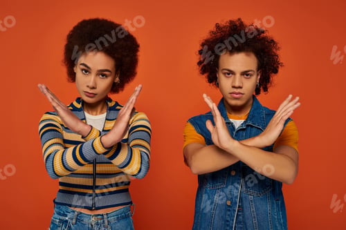 Preview: african american brother and sister showing denial gesture looking at camera, family concept