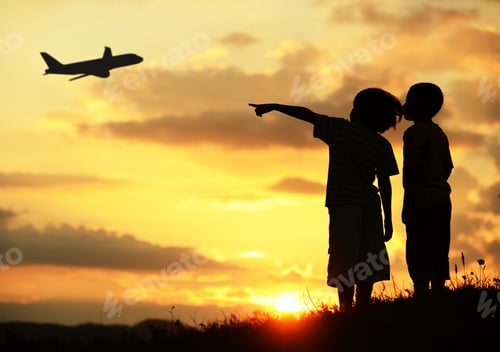 Preview: Two Kids Silhouette On Meadow Looking At Airplane In Air