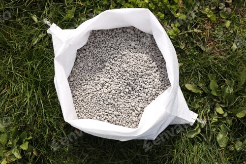 Preview: Fertilizer in bag on green grass outdoors, top view