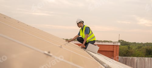 Preview: Engineer service check installation solar cell on the roof of factory.