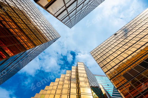 Preview: Golden skyscrapper building with blue sky in Hong Kong. Windows glass of modern office