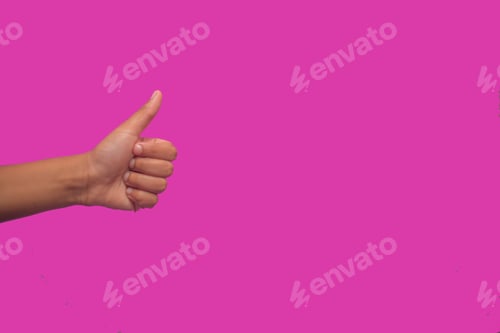 Preview: Hand showing thumbs up gesture against pink background with copy space