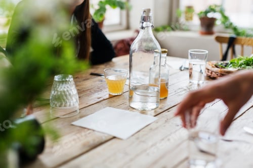 Preview: Woman with drinks sitting at cafe table