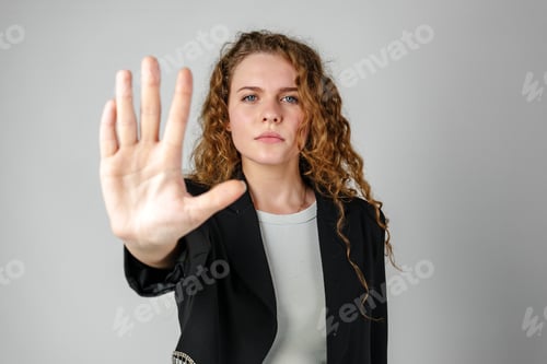 Preview: Woman With Curly Hair Holding Hand Up