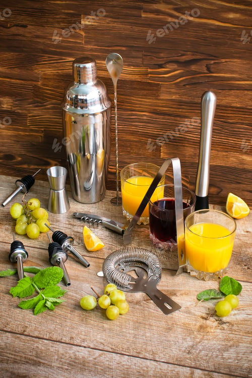 Preview: Fresh orange juice lemonade summer drink, sliced lemon,green mint in glasses,Barman bartender tools