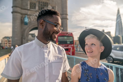 Preview: Young couple walking outdoors, Tower Bridge in background