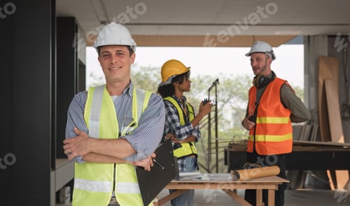 Preview: Portrait of an engineer standing and looking at the camera with a team of professional engineers