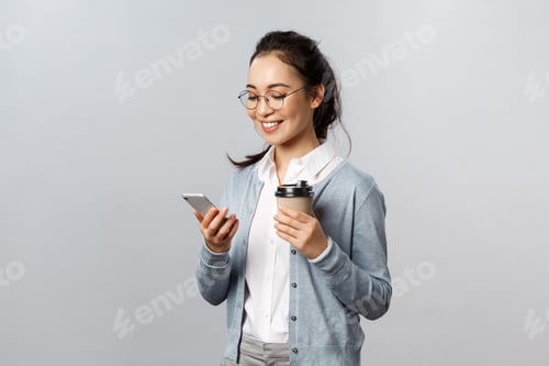 Preview: Office lifestyle, business and people concept. Attractive young korean woman checking her phone