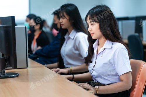Preview: East Asian females in a professional office setting using a computer monitor for work