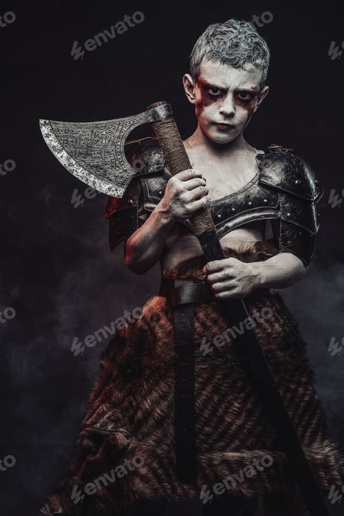 Preview: Holding an axe little barbarian with painted skin in dark background