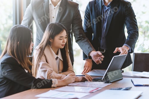 Preview: Group of young business people brainstorm collaboration ideas at the office.