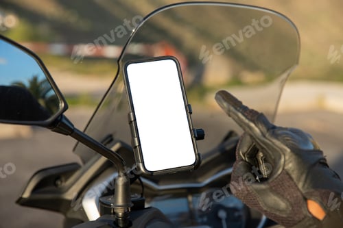 Preview: Close-up of a biker's hand pointing at the blank screen with mockup of his smartphone on the scooter