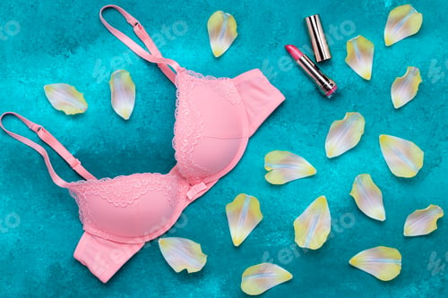 Preview: Pink smooth bra and gold lipstick on a turquoise background. Sexy silk brassiere