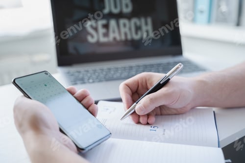 Preview: Remote job search at home. Man appoints interview for vacancy in mobile phone, types meeting date