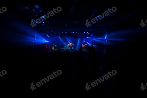 Preview: Rock group performing before the audience at a live concert.