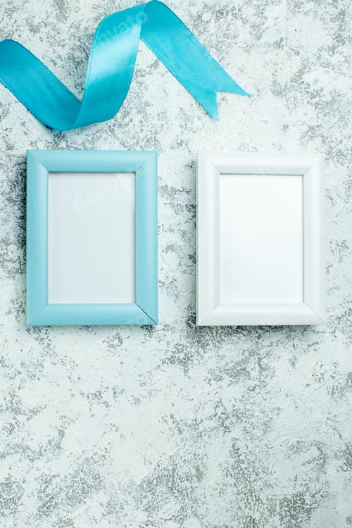 Preview: top view two blank photo frames blue ribbon on grey background copy place
