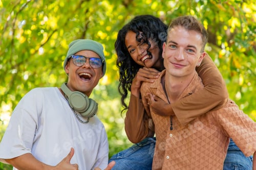 Preview: Happy multiethnic friends having fun together in a park