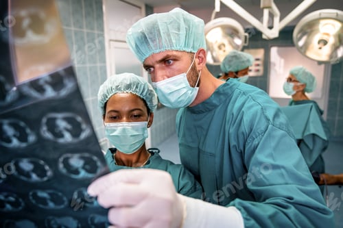 Preview: Healthcare and medical concept. Group of doctors looking at x-ray before operation