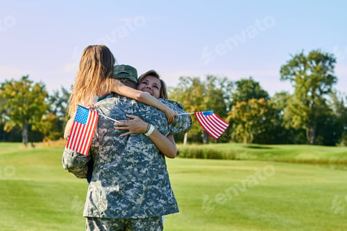 Preview: American soldier reunited with his family in park.